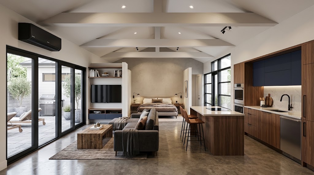 Finished garage conversion with open-concept kitchen, living area, bedroom nook, and sliding glass doors to a patio